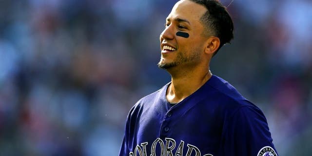 DENVER, CO - JULY 11: Carlos Gonzalez #5 of the Colorado Rockies smiles after he hit a walk-off RBI single against the Atlanta Braves in the ninth inning at Coors Field on July 11, 2015 in Denver, Colorado. The Rockies defeated the Braves 3-2. (Photo by Justin Edmonds/Getty Images)