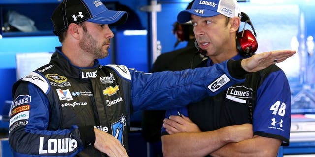 LONG POND, PA - JUNE 06: Jimmie Johnson, driver of the #48 Lowe's/Jimmie Johnson Foundation Chevrolet, left, talks with crew chief Chad Knaus in the garage area during practice for the NASCAR Sprint Cup Series Axalta 'We Paint Winners' 400 at Pocono Raceway on June 6, 2015 in Long Pond, Pennsylvania. (Photo by Nick Laham/Getty Images)