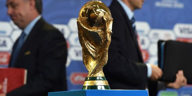 The FIFA World Cup trophy stands on a podium at a hall close to the Constantine (Konstantinovsky) Palace in St. Petersburg on July 24, 2015 on the eve of the Preliminary draw for the 2018 FIFA World Cup. The trophy created by Italian sculptor Silvio Gazzaniga for the 1974 World Cup, measures 36cm in height, is made out of 18-carat gold and weighs 6175g. AFP PHOTO / KIRILL KUDRYAVTSEV (Photo credit should read KIRILL KUDRYAVTSEV/AFP/Getty Images)