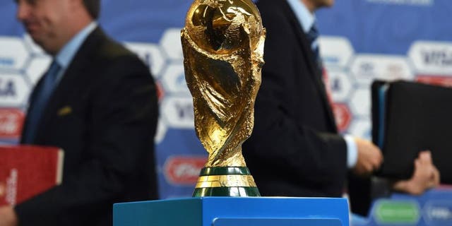 The FIFA World Cup trophy stands on a podium at a hall close to the Constantine (Konstantinovsky) Palace in St. Petersburg on July 24, 2015 on the eve of the Preliminary draw for the 2018 FIFA World Cup. The trophy created by Italian sculptor Silvio Gazzaniga for the 1974 World Cup, measures 36cm in height, is made out of 18-carat gold and weighs 6175g. AFP PHOTO / KIRILL KUDRYAVTSEV (Photo credit should read KIRILL KUDRYAVTSEV/AFP/Getty Images)