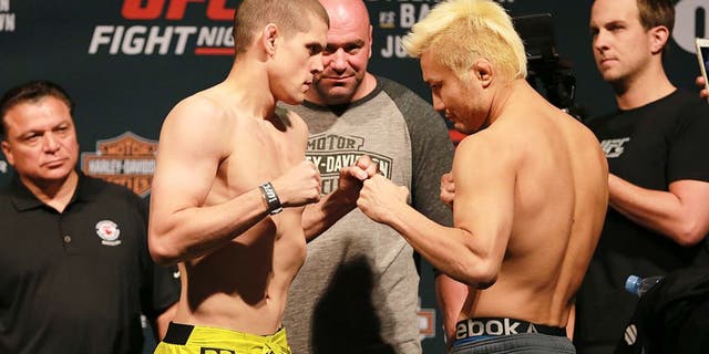 CHICAGO, IL - JULY 24: (L-R) Opponents Joe Lauzon and Takanori Gomi of Japan face off during the UFC weigh-in at the United Center on July 24, 2015 in Chicago, Illinois. (Photo by Rey Del Rio/Zuffa LLC/Zuffa LLC via Getty Images)