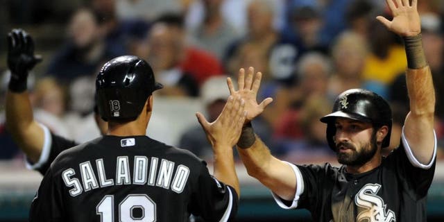Jul 24, 2015; Cleveland, OH, USA; Chicago White Sox third baseman Tyler Saladino (18) and Chicago White Sox center fielder Adam Eaton (1) celebrate after scoring during the eighth inning against the Cleveland Indians at Progressive Field. Mandatory Credit