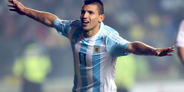 Argentina's forward Sergio Aguero (L) celebrates after scoring against Paraguay during their Copa America semifinal football match in Concepcion, Chile on June 30, 2015. AFP PHOTO / YURI CORTEZ (Photo credit should read YURI CORTEZ/AFP/Getty Images)