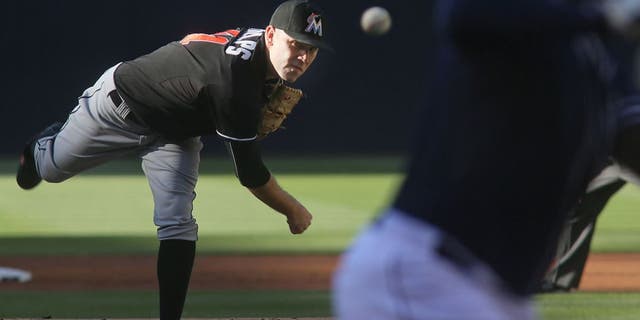 Miami Marlins starting pitcher David Phelps throws to a San Diego Padres batter during the first inning of a baseball game Saturday, July 25, 2015, in San Diego. (AP Photo/Sandy Huffaker)