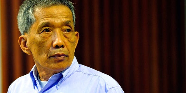 July 26: Khmer Rouge jailer Kaing Guek Eav, who ran a top secret detention center for the worst "enemies" of the state, looks on during his sentencing at the U.N.-backed war crimes tribunal in Phnom Penh, Cambodia.