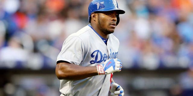 NEW YORK, NY - JULY 24: Yasiel Puig #66 of the Los Angeles Dodgers rounds first after his two run home run in the third inning against the New York Mets on July 24, 2015 at Citi Field in the Flushing neighborhood of the Queens borough of New York City. (Photo by Elsa/Getty Images)