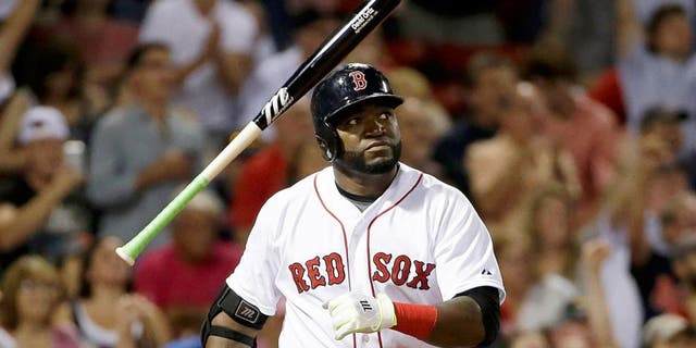 Boston Red Sox's David Ortiz tosses the bat as he watches the flight of his three-run home run in the fifth inning of a baseball game against the Detroit Tigers at Fenway Park, Sunday, July 26, 2015, in Boston. Ortiz homered twice and drove in a career-high seven runs to lead the Red Sox to an 11-1 victory. (AP Photo/Steven Senne)