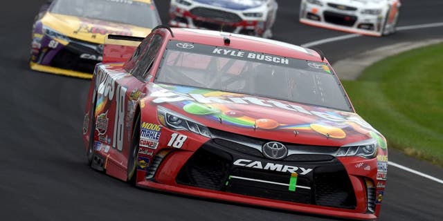 INDIANAPOLIS, IN - JULY 26: Kyle Busch, driver of the #18 Skittles Toyota, leads a pack of cars during the NASCAR Sprint Cup Series Crown Royal Presents the Jeff Kyle 400 at the Brickyard at Indianapolis Motor Speedway on July 26, 2015 in Indianapolis, Indiana. (Photo by Rainier Ehrhardt/NASCAR via Getty Images)