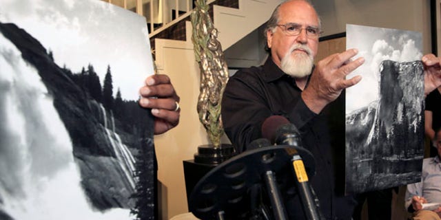 July 27: Rick Norsigian holds up a photograph made from a glass negative shot by the late photographer Ansel Adams during a news conference in Beverly Hills. A lawyer says the trove of old glass negatives found in a garage sale for $45 by Norsigian has been authenticated as the work of photographer Ansel Adams and is worth at least $200 million.