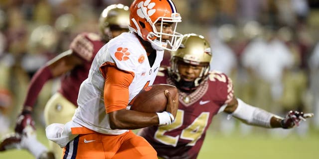 Sep 20, 2014; Tallahassee, FL, USA; Clemson Tigers quarterback Deshaun Watson (4) scrambles up the field against Florida State Seminoles linebacker Terrance Smith (24) during the first quarter at Doak Campbell Stadium. Mandatory Credit: John David Mercer-USA TODAY Sports