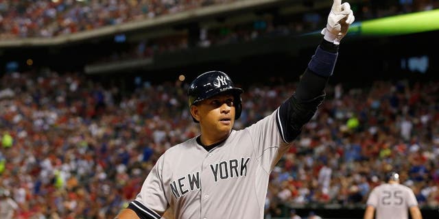 Jul 27, 2015; Arlington, TX, USA; New York Yankees designated hitter Alex Rodriguez (13) celebrates a solo home run in the sixth inning against the Texas Rangers at Globe Life Park in Arlington. Mandatory Credit: Matthew Emmons-USA TODAY Sports