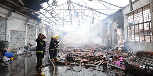 July 28: Firemen put out a fire in Nanjing after a powerful blast caused by a suspected gas leak rocked a plastics factory in eastern China, killing at least 12 people and seriously injuring 28.