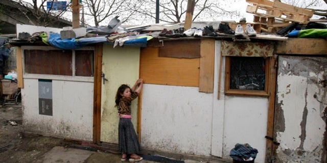 March 26: A young gypsy girl is seen in a makeshift camp in Saint Denis, a northern suburb of Paris.