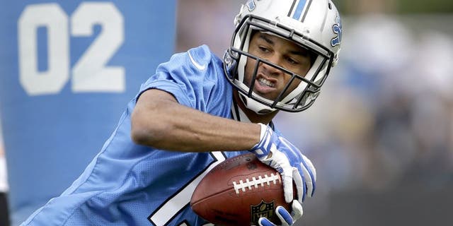 Detroit Lions wide receiver Golden Tate catches a pass during NFL football training camp in Allen Park, Mich., Monday, July 28, 2014. (AP Photo/Paul Sancya)