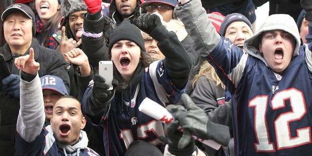 BOSTON - FEBRUARY 4: Patriots fans cheer as the Super Bowl victory parade made its way up Boylston Street in Boston on February 4, 2015. (Photo by Wendy Maeda/The Boston Globe via Getty Images)