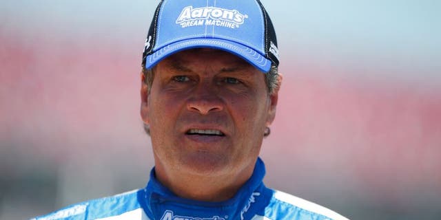 TALLADEGA, AL - MAY 02: Michael Waltrip, driver of the #55 Aaron's Dream Machine Toyota, stands on the grid during qualifying for the NASCAR Sprint Cup Series GEICO 500 at Talladega Superspeedway on May 2, 2015 in Talladega, Alabama. (Photo by Matt Sullivan/Getty Images)