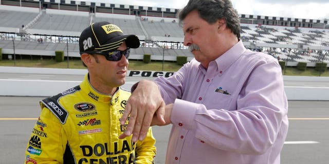 LONG POND, PA - JUNE 05: Matt Kenseth, driver of the #20 Dollar General Toyota, left, talks with Vice Chairman of NASCAR Mike Helton on the grid prior to qualifying for the NASCAR Sprint Cup Series Axalta "We Paint Winners" 400 at Pocono Raceway on June 5, 2015 in Long Pond, Pennsylvania. (Photo by Todd Warshaw/NASCAR via Getty Images)