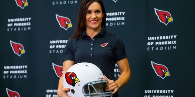 Jul 28, 2015; Tempe, AZ, USA; Arizona Cardinals inside linebackers intern and preseason coach Jen Welter holds a helmet as she poses for a photo during a press conference at the teams training facility. Mandatory Credit: Mark J. Rebilas-USA TODAY Sports