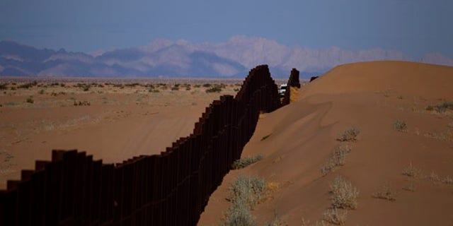 July 28: A US border patrol vehicle drives along the U.S.-Mexico border fence near Yuma, Arizona.