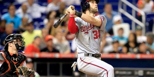 Jul 29, 2015; Miami, FL, USA; Washington Nationals right fielder Bryce Harper (34) hits a home run in the eighth inning against the Miami Marlins at Marlins Park. Mandatory Credit: Robert Mayer-USA TODAY Sports