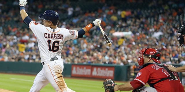 Jul 28, 2015; Houston, TX, USA; Houston Astros catcher Hank Conger (16) hits a double against the Los Angeles Angels in the sixth inning at Minute Maid Park. Astros won 10-5. Mandatory Credit: Thomas B. Shea-USA TODAY Sports