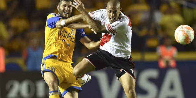 River Plate's Jonathan Maidana (R) vies for the ball with Tigres's Andre Gignac (L) during their Copa Libertadores final match, first leg, at the University stadium in Monterrey, Mexico on July 29, 2015. AFP PHOTO/ Yuri CORTEZ (Photo credit should read YURI CORTEZ/AFP/Getty Images)