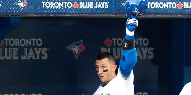 Toronto Blue Jays' Troy Tulowitzki tips his helmet after hitting a two-run home run during the third inning of a baseball game against the Philadelphia Phillies, Wednesday, July 29, 2015, in Toronto. (Darren Calabrese/The Canadian Press via AP) MANDATORY CREDIT