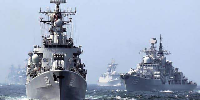 In this May 24, 2014, file photo, China's Harbin (112) guided missile destroyer and DDG-139 Ningbo Sovremenny class Type-956EM destroyer, right, take part in a week-long China-Russia "Joint Sea-2014" navy exercise at the East China Sea off Shanghai, China. A Chinese navy task force wrapped up visits to four Persian Gulf states as the increasingly capable maritime force grows its presence in the strategically vital region. The three ships, including Harbin, departed Kuwait on Sunday, Feb. 5, 2017, after stopping in Saudi Arabia, Qatar and the United Arab Emirates, the Defense Ministry said on its website Monday, Feb. 6, 2017. (Chinatopix via AP)