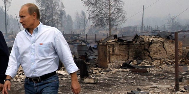 July 30: Russian Prime Minister Vladimir Putin tours the village of Verkhnyaya Vereya, where all 341 houses have burned to the ground.