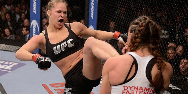 LAS VEGAS, NV - DECEMBER 28: (L-R) Ronda Rousey kicks Miesha Tate in their UFC women's bantamweight championship bout during the UFC 168 event at the MGM Grand Garden Arena on December 28, 2013 in Las Vegas, Nevada. (Photo by Donald Miralle/Zuffa LLC/Zuffa LLC via Getty Images)