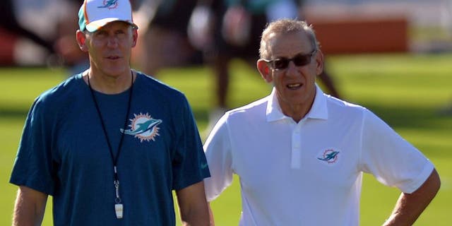 Jul 25, 2014; Davie, FL, USA; Miami Dolphins head coach Joe Philbin (left) talks with the Dolphins owner Stephen Ross (right) at Miami Dolphins Training Facility. Mandatory Credit: Steve Mitchell-USA TODAY Sports