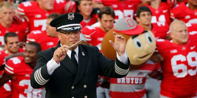 Sept. 7, 2013: Ohio State University marching band director Jonathan Waters leads the band in "Carmen Ohio" following an NCAA football game against San Diego State at Ohio Stadium in Columbus, Ohio.