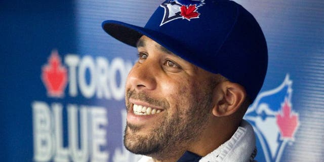 Toronto Blue Jays newly acquired starting pitcher David Price smiles in the dugout as his team plays the Kansas City Royals during the second inning of a baseball game, Friday, July 31, 2015 in Toronto. (Fred Thornhill/The Canadian Press via AP) MANDATORY CREDIT