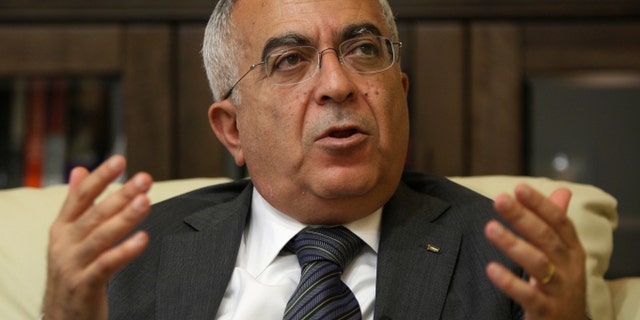FILE - In this Tuesday, June 28, 2011 file photo, Palestinian Prime Minister Salaam Fayyad speaks during an interview with The Associated Press in the West Bank city of Ramallah. Palestinian officials say Fayyad has officially submitted his resignation, and is waiting for a reply from President Mahmoud Abbas.(AP Photo/Majdi Mohammed, File)