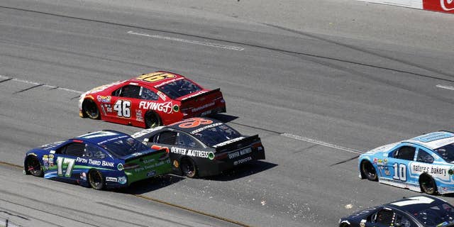 Ricky Stenhouse Jr. and Martin Truex Jr. make contact during the Sprint Cup auto race at Richmond International Raceway in Richmond, Va., Sunday, April 24, 2016. (AP Photo/Chet Strange)