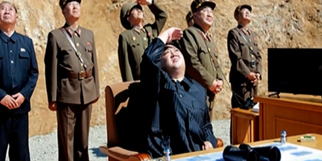 North Korean leader Kim Jong Un watches the launch of an intercontinental ballistic missile.