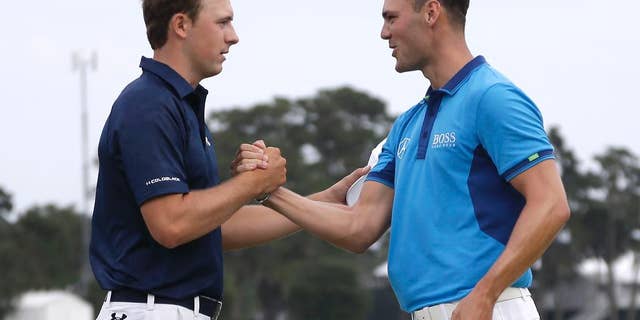 Jordan Spieth, left, and Martin Kaymer of Germany, shake hands at the end of the third round of The Players championship golf tournament at TPC Sawgrass, Saturday, May 10, 2014 in Ponte Vedra Beach, Fla. (AP Photo/Lynne Sladky)