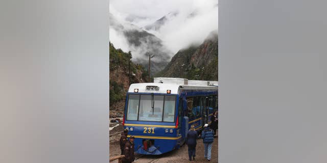 FILE - In this April 1, 2010 file photo, a train waits for passengers at the Piscacucho train station prior to departing toward the citadel of Machu Picchu in Cuzco, Peru. A local protest has temporarily suspended the train service on Tuesday, Nov. 15, 2016 that takes tourists to the ancient Incan citadel of Machu Picchu, the most visited place in Peru. (AP Photo/Karel Navarro, File)