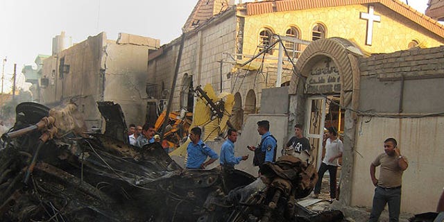 Aug. 2: Iraqis inspect the site of an early morning car bomb attack in front of a Church in Kirkuk, 180 miles north of Baghdad, Iraq.