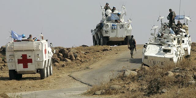 Aug. 1: Spanish United Nations peacekeepers atop armored vehicles patrol the border in the southeastern Wazzani River area, Lebanon.