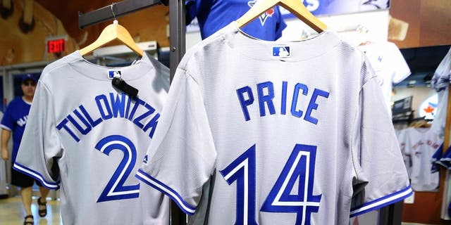 TORONTO, ON- JULY 30 - Not long after Toronto Blue Jays General Manager Alex Anthopoulos announces his trade with the Detroit Tigers for starting pitcher David Price workers in the Jays Shop started making number 14 David Price jerseys. The staff is still busy making Troy Tulowitzki number 2 jerseys in Toronto. July 30, 2015. (Steve Russell/Toronto Star via Getty Images)