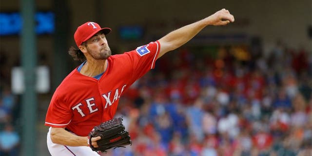 Texas Rangers starting pitcher Cole Hamels throws during the first inning of a baseball game against the San Francisco Giants in Arlington, Texas, Saturday, Aug. 1, 2015. (AP Photo/LM Otero)