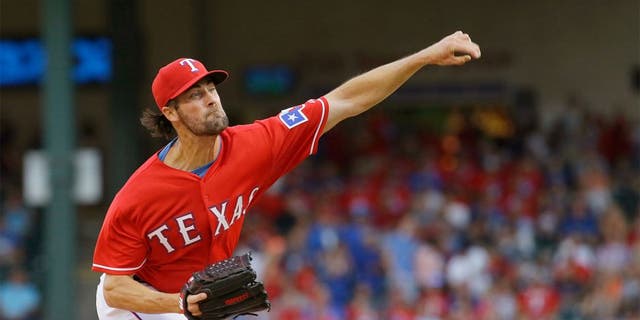 Texas Rangers starting pitcher Cole Hamels throws during the first inning of a baseball game against the San Francisco Giants in Arlington, Texas, Saturday, Aug. 1, 2015. (AP Photo/LM Otero)