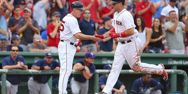 BOSTON, MA - AUGUST 1: Travis Shaw #47 of the Boston Red Sox celebrates with third base coach Brian Butterfield #55 of the Boston Red Sox after his second home run against the Tampa Bay Rays in the eighth inning at Fenway Park on August 1, 2015 in Boston, Massachusetts. (Photo by Jim Rogash/Getty Images)