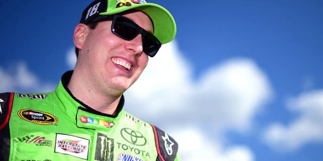 LONG POND, PA - JULY 31: Kyle Busch, driver of the #18 M&M's Crispy Toyota, looks on from the grid during qualifying for the NASCAR Sprint Cup Series Windows 10 400 at Pocono Raceway on July 31, 2015 in Long Pond, Pennsylvania. (Photo by Jared C. Tilton/Getty Images)