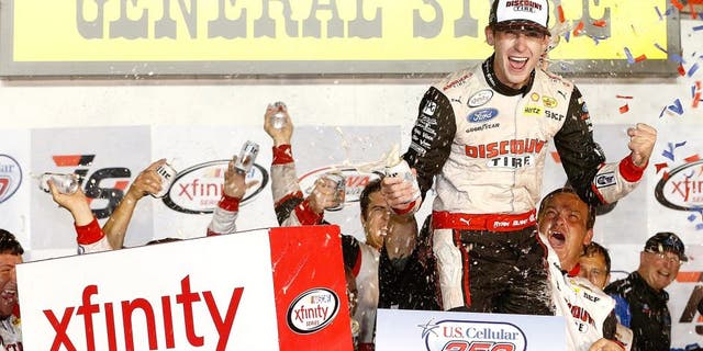 NEWTON, IA - AUGUST 01: Ryan Blaney, driver of the #22 Discount Tire Ford, celebrates in victory lane after winning the NASCAR XFINITY Series U.S. Cellular 250 at Iowa Speedway on August 1, 2015 in Newton, Iowa. (Photo by Brian Lawdermilk/NASCAR via Getty Images)