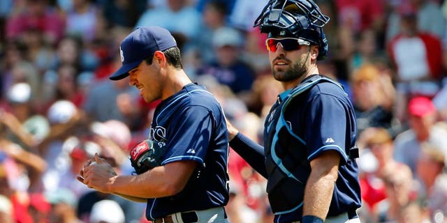 Tampa Bay Rays starting pitcher Matt Moore gets a pat on the back from catcher Curt Casali after giving up a run to the Boston Red Sox during the second inning of a baseball game at Fenway Park in Boston Saturday, Aug. 1, 2015. (AP Photo/Winslow Townson)