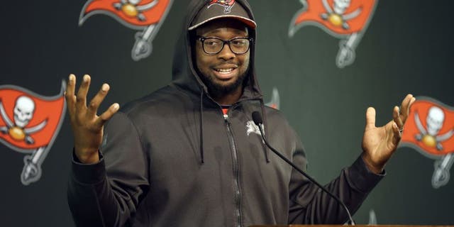 Tampa Bay Buccaneers defensive tackle Gerald McCoy gestures while speaking to reporters during an NFL football training camp news conference Saturday, Aug. 1, 2015, in Tampa, Fla. The first day of the team's training camp was canceled due to inclement weather. (AP Photo/Chris O'Meara)