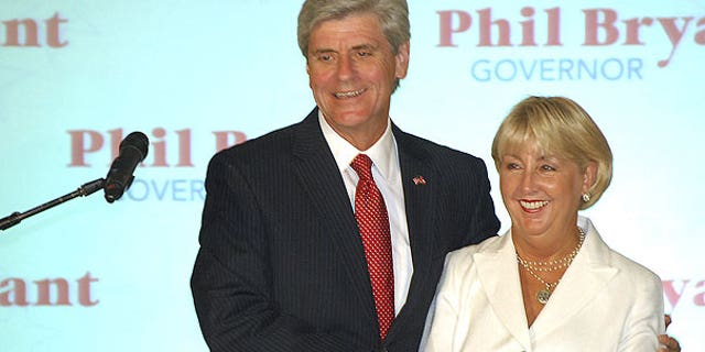 Aug. 2: Gubernatorial candidate Phil Bryant holds wife, Debra, as he greets supporters after being declared the winner of the Republican primary at the Old Capitol Inn in downtown Jackson, Miss.