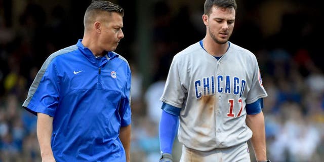 Aug 2, 2015; Milwaukee, WI, USA; Chicago Cubs third baseman Kris Bryant (17) is escorted off the field by a trainer after an injury in the fifth inning during the game against the Milwaukee Brewers at Miller Park. Mandatory Credit: Benny Sieu-USA TODAY Sports